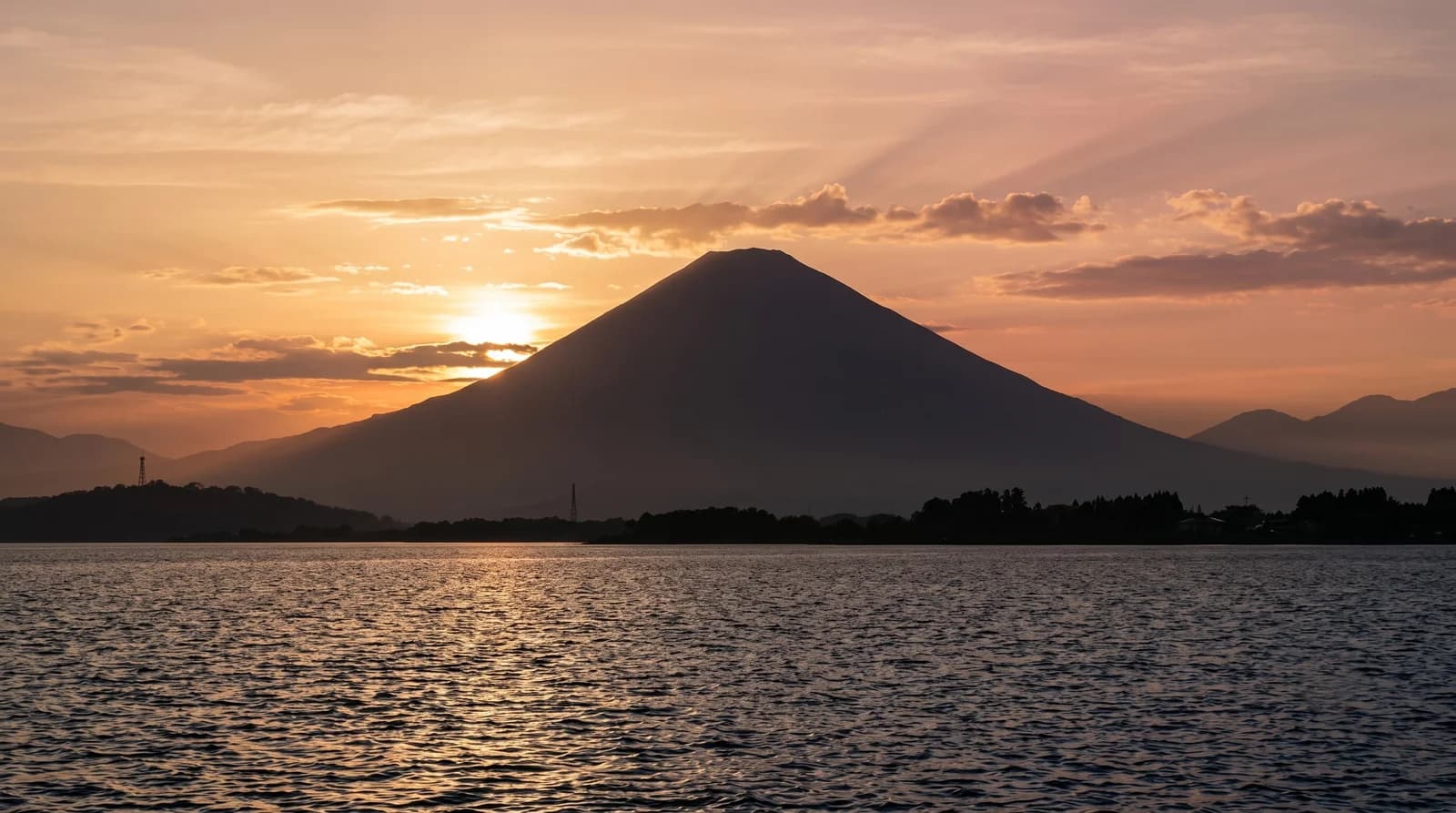 Breathtaking Agung Sunset Nusa Penida, showcasing Mount Agung behind tranquil beach landscapes during a Bali tour.
