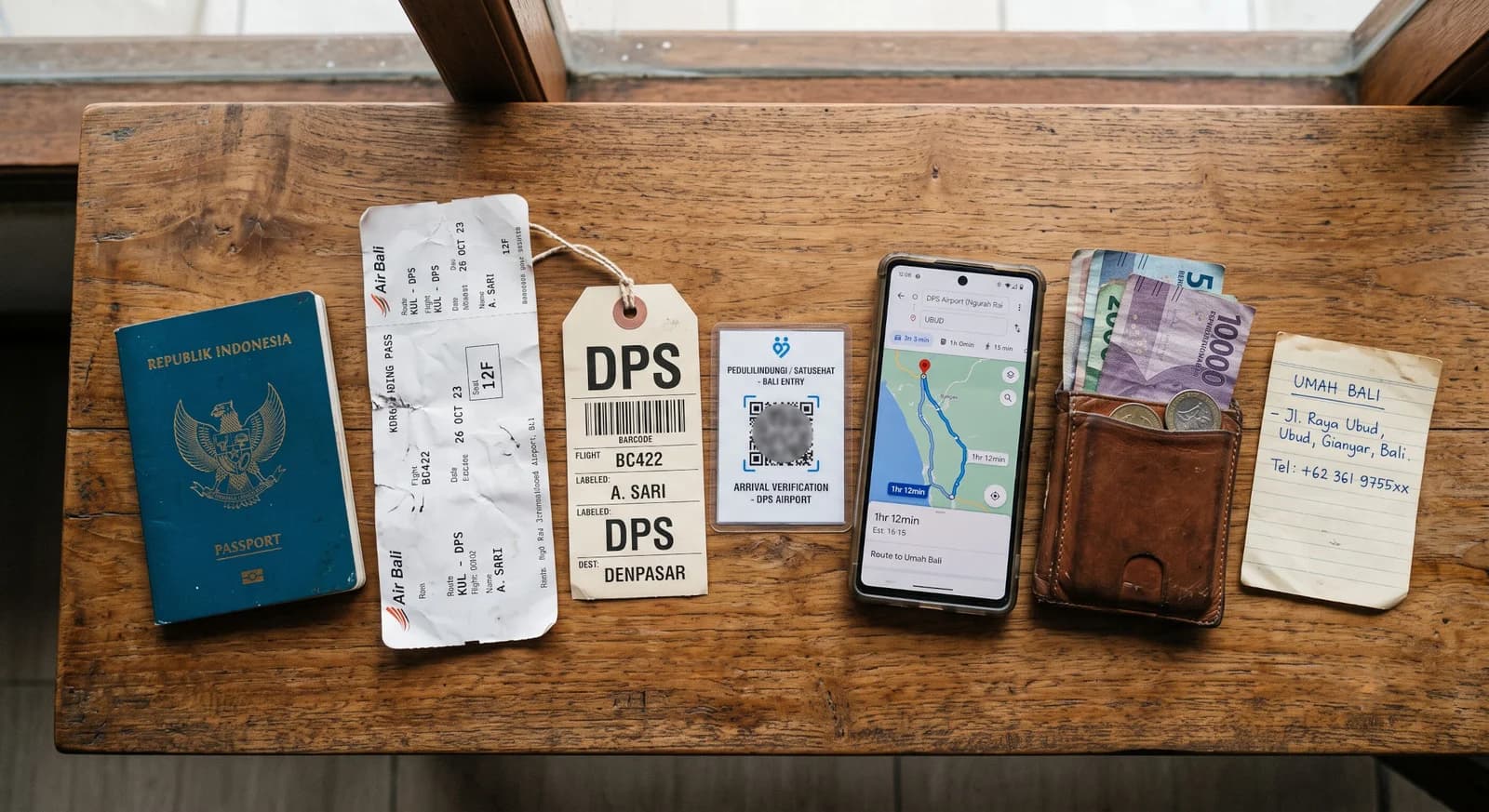 Bali airport arrival flow with passport, baggage tag, QR code, phone, and hotel address.