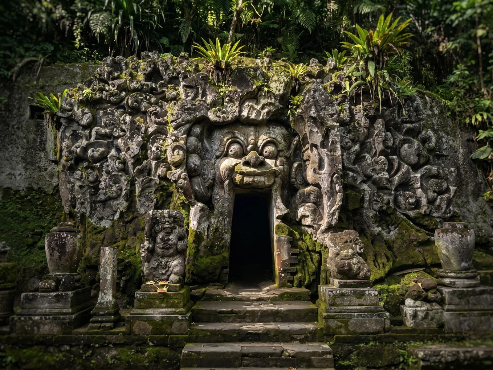 The demon-mouth cave entrance of Goa Gajah carved into the rock.