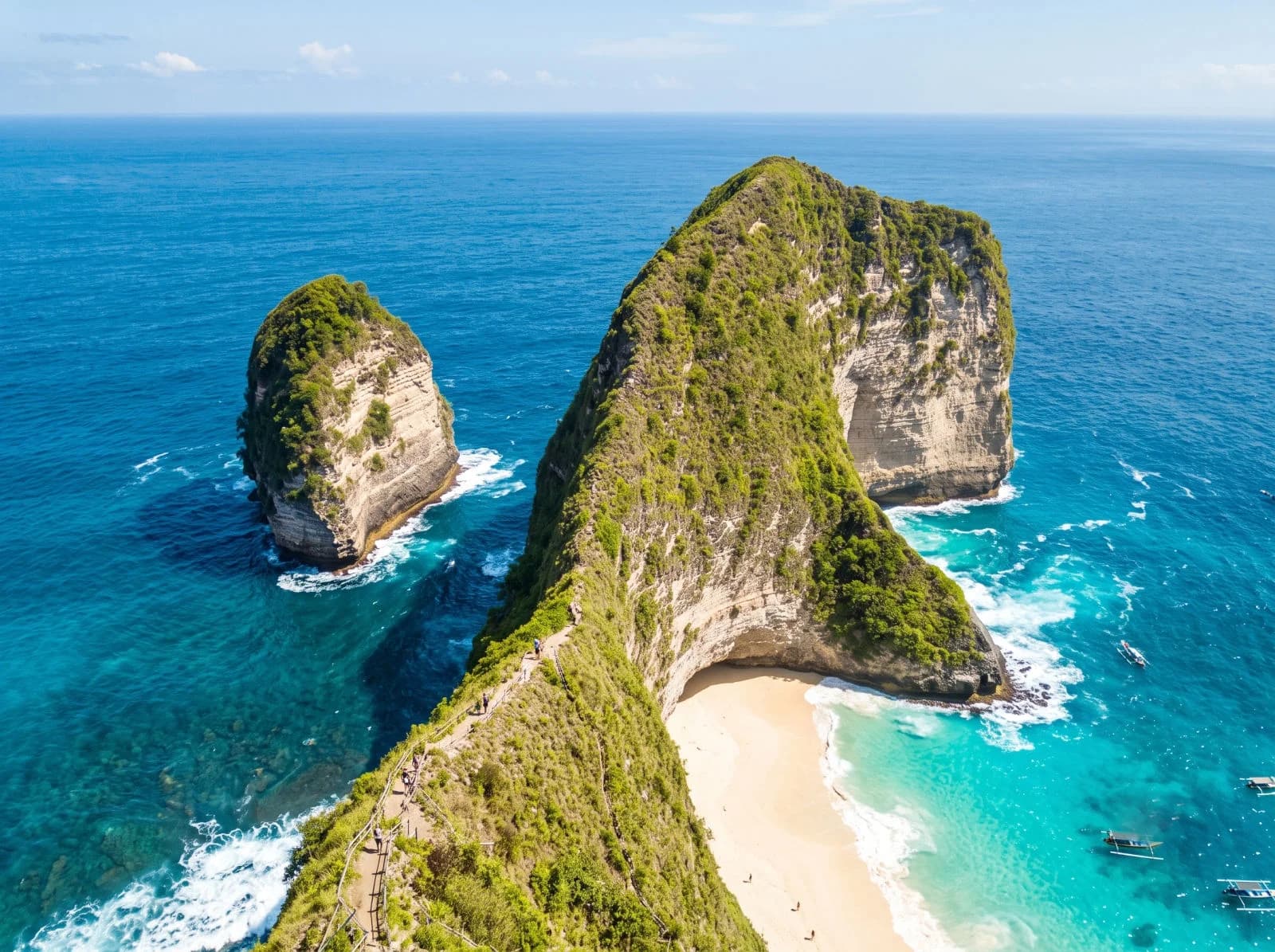 The T-Rex-shaped Kelingking headland on Nusa Penida with a white beach far below.