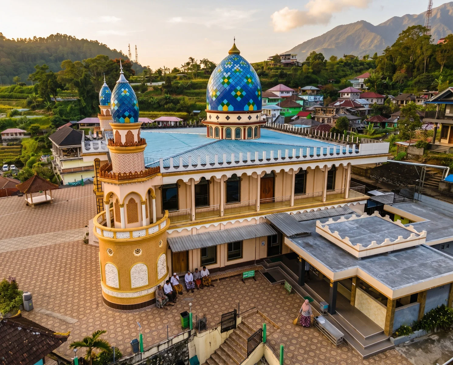A mosque minaret, church steeple, and Hindu temple gate on the same street at dusk